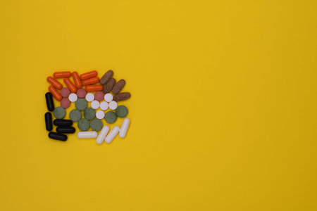 Pills and capsules on a yellow background. mock up. Layout
