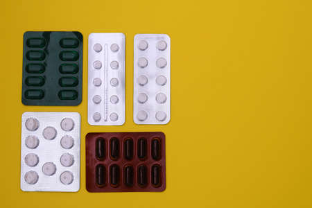 painkillers, antibiotics, vitamins and tablets in a blister pack. layout. mock upの写真素材