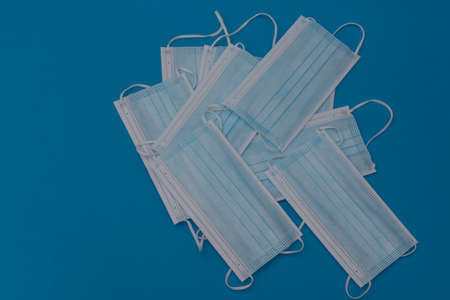 Protective face masks on a blue background. layoutの写真素材