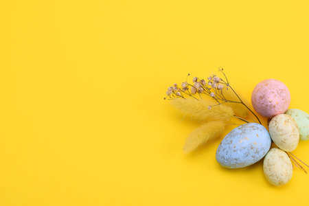 Top view of a colorful easter eggs on a yellow background. free space