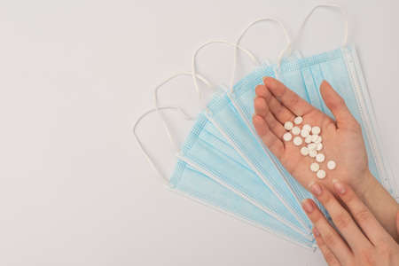 Pills in hand, medical masks. mock upの写真素材