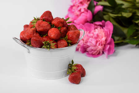 strawberries in a bucket on a white background.の写真素材