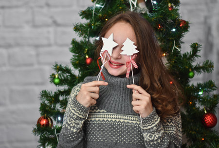 funny girl on the background of a Christmas tree.