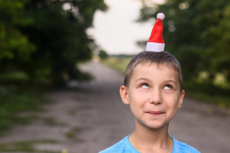 funny boy put a little Santa hat on his head. mock up