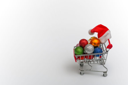 shopping basket with Christmas balls and a Christmas hat. copy space