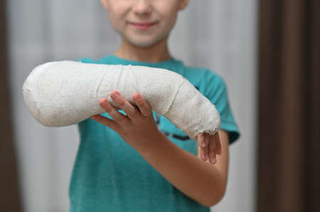 a boy with a broken arm in a cast. close-up.の写真素材