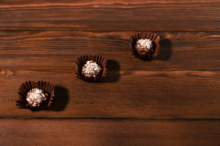 homemade chocolates on textured wooden boards. Healthy dessert.