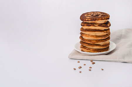 A stack of pancakes on a white plate. on a white background. empty spaceの写真素材