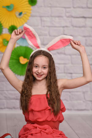 a beautiful girl and rabbit ears. happy Easter. verticalの写真素材