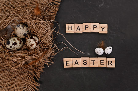 Easter eggs in a nest on a on burlap on black background. concept. Top view. Card with a happy...