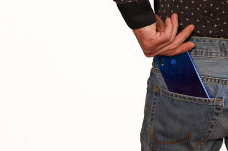 man puts out a smartphone from the back pocket. on a white backgroundの写真素材