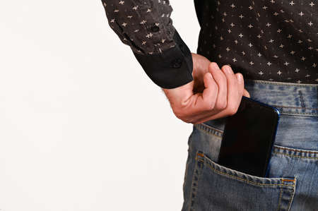 take your phone out of the back pocket of your trousers. isolatedの写真素材
