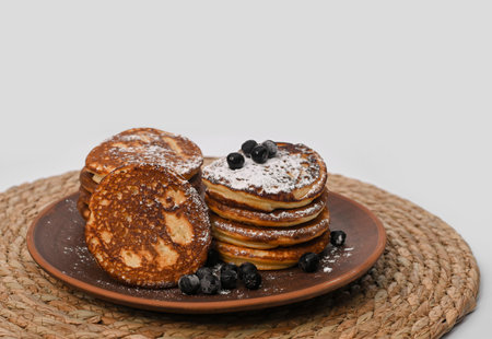 pancakes with berries in a clay plate.
