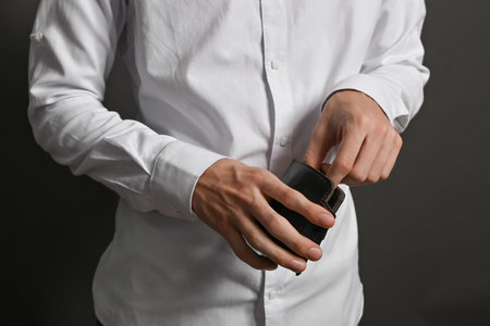 The wallet in his hands is a close-up. The concept