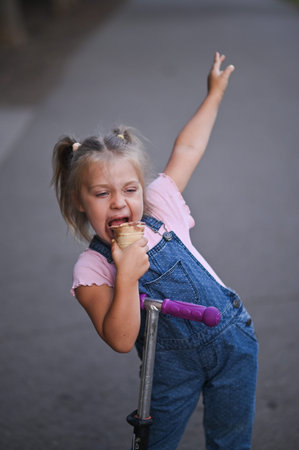 A little girl with an appetite for ice cream. vertical