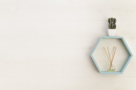 hexagonal wooden shelf on the wall with flower and aroma diffuser. mock upの写真素材
