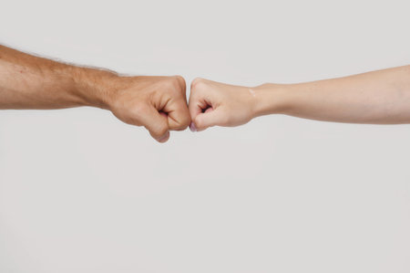 a mans fist against a womans fist.の写真素材