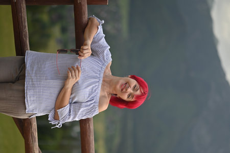 A middle-aged woman with red hair against the background of natureの写真素材