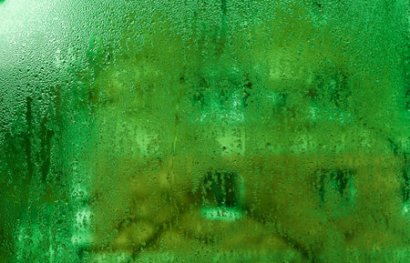 The background is wet glass. green textureの写真素材