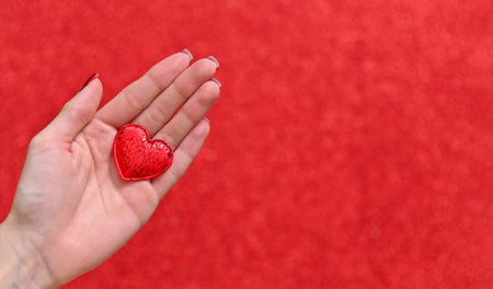 a heart in a woman's hand. concept of love