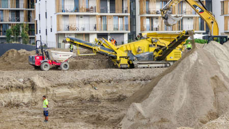 Construction machinery in action as a new apartment house is being builtのeditorial素材