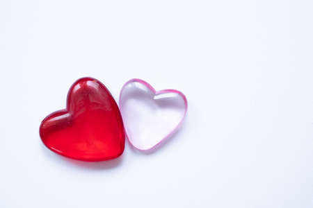Valentine`s day background with two hearts. Shiny glass hearts on white background.の写真素材