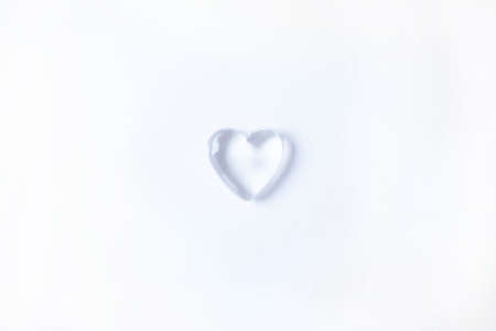 Valentine`s day background with heart bubble. Copy space. Shiny glass heart on white background.の写真素材