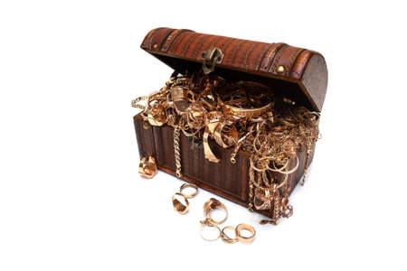 Old used gold jewelry in a wooden box on white background.の写真素材