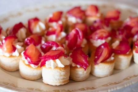 Plate with light canapes. Buffet style catering table setting.の写真素材