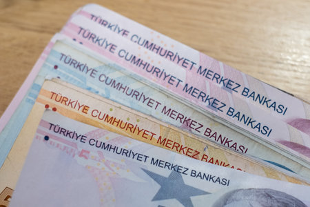 Turkish lira banknotes in hand. The paper currency of Turkey. Current Turkish liras are issued by...