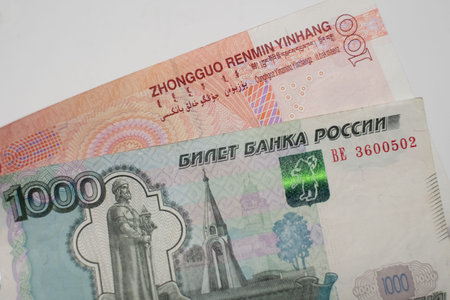 Chinese yuan and Russian ruble banknotes. Financial system of Russia and China. De-dollarization....