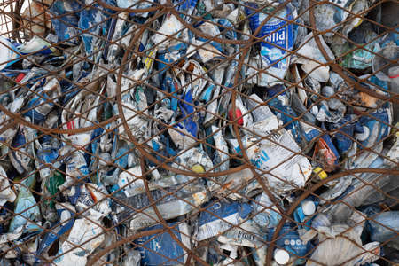 PÃ¤rnu, Estonia - June 5, 2021: Large wire trash container for collecting plastic waste from beach. Garbage bin for used plastic bottles and other waste. Full frame.のeditorial素材