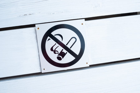 No smoking sign on a white wooden fence.の写真素材