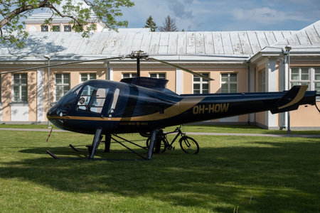 PÃ¤rnu, Estonia - June 5, 2021: Helicopter parked in front of Hedon Spa Hotel during beautiful sunny summer day. Civil helicopter Enstrom 480B, OH-HOW parked in a city park.のeditorial素材