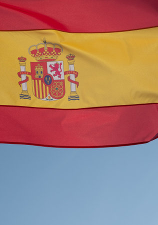 Spanish flag waving in wind. Flag of Spain on blue sky background.の写真素材