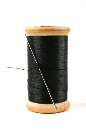 Old fashioned wooden cotton reel with needle and thread.の写真素材
