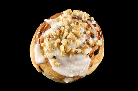 Delicious sweet iced bun with walnuts and coconut.の写真素材