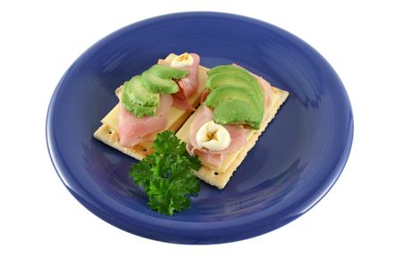 Ham, cheese and avocado crackers with hot english mayo.の写真素材