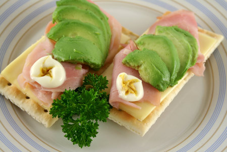 Ham, cheese and avocado crackers with hot english mayo.