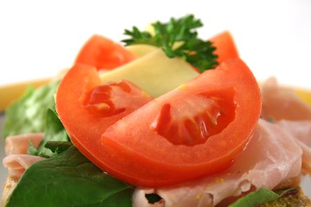 Tomato, ham, lettuce and cheese open sandwich on wholemeal bread.  の写真素材