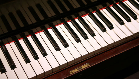 Piano keys on an old fashioned upright piano keyboard.