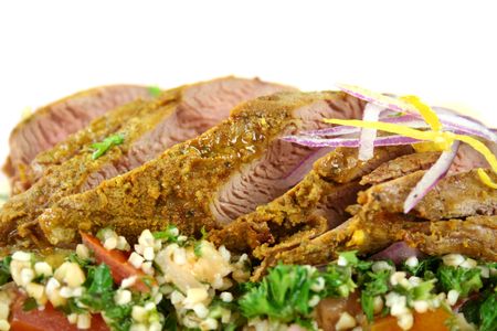 Sliced Middle Eastern lamb fillet with hommus and tabouleh.の写真素材