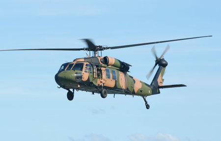 Australian Army Blackhawk chopper flies by.