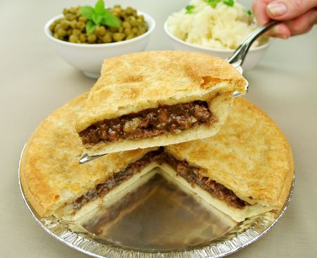 Slice of beef pie with peas and mashed potato ready to serve.の写真素材