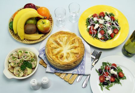 Delicious baked ham and egg pie with potato and salad ready to serve.の写真素材