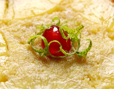 Delightful glace cherry with shredded lime rind on top a cake.の写真素材