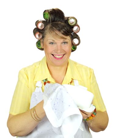 Frumpy housewife wiping up the dishes with a smile.の写真素材