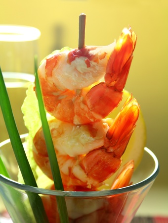 Delicious fresh shrimp cocktail with an avocado salad with spring onions.の写真素材