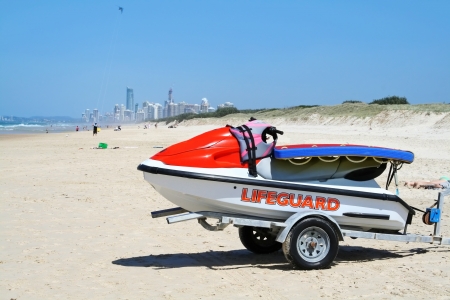 Lifeguard jet ski sits on the beach with Surfers Paradise in the background on the Gold Coast Australia の写真素材