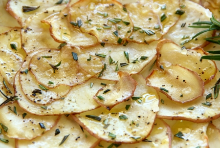 Delicious crispy baked potato chips with rosemary ready to serve.の写真素材